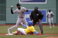 Boston Red Sox's Enrique Hernandez, bottom, is out at second as Chicago White Sox shortstop Tim Anderson (7) throws to first to complete the double play during the first inning of a baseball game, Saturday, April 17, 2021, in Boston. (AP Photo/Mary Schwalm)