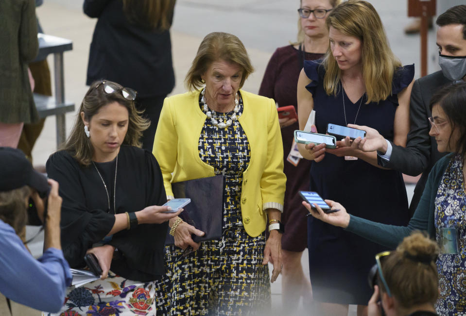 FILE - In this June 10, 2021, file photo Sen. Shelley Moore Capito, R-W.Va., former lead GOP negotiator on President Joe Biden's infrastructure package, is met by reporters as she walks to the chamber for a vote, at the Capitol in Washington. President Joe Biden’s hopes of channeling billions of dollars into green infrastructure investments to fight climate change are running into the political obstacle of winning over Republican lawmakers who oppose that approach as unnecessary, excessive spending. (AP Photo/J. Scott Applewhite, File)