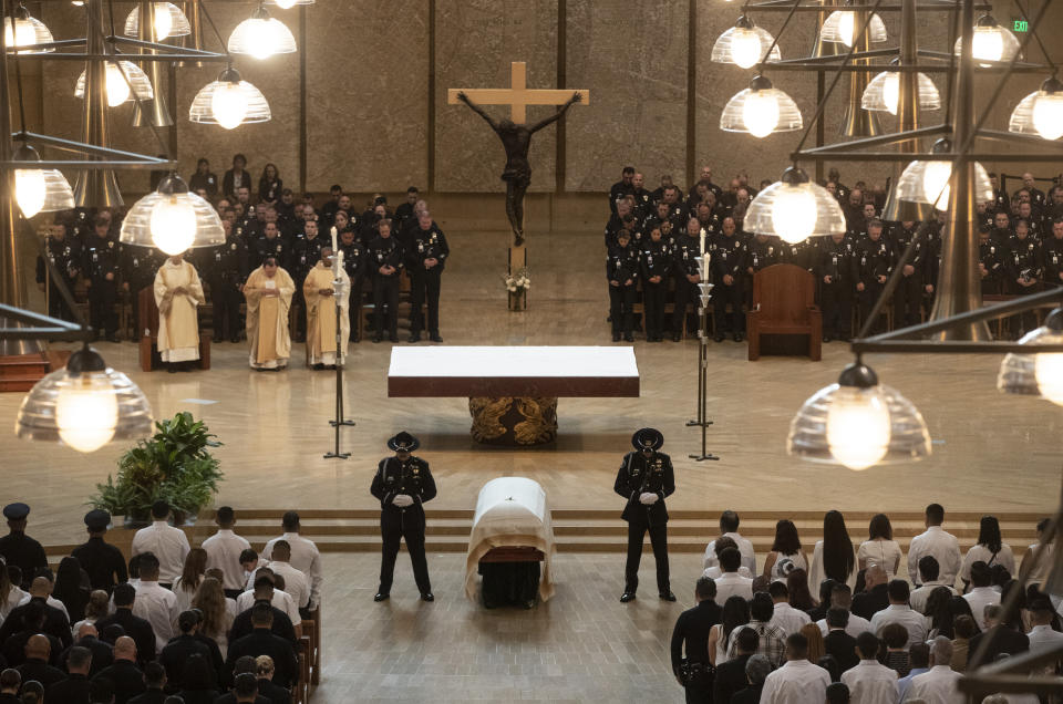 Honor guards flank Juan Diaz's casket during funeral mass for the slain LAPD officer at the Cathedral of Our Lady of the Angels in Los Angeles, Calif., on Monday, Aug. 12, 2019. (Brian van der Brug/Los Angeles Times via AP, Pool)