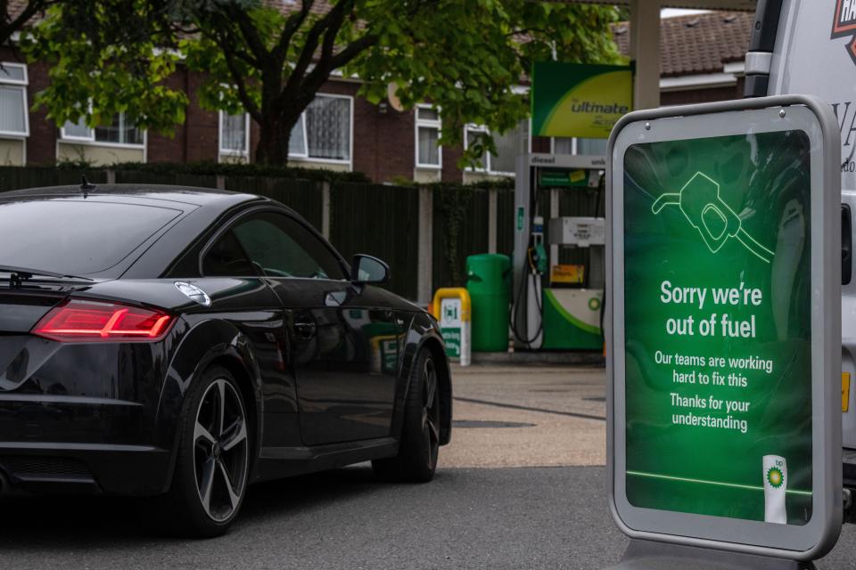 A car drives past a sign informing customers that they are out of fuel at a BP garage on Sunday in Grove Park, London (Getty)