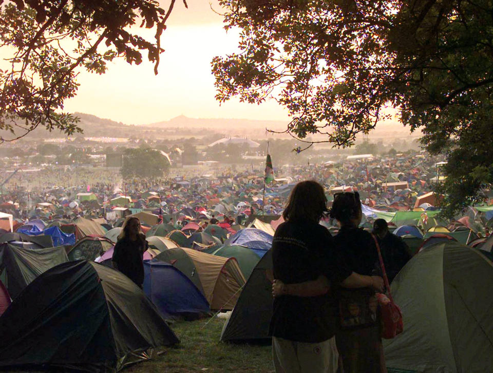 Festival campers admire the sunset at dusk as a day's boogying is over and the night begins in 1999.