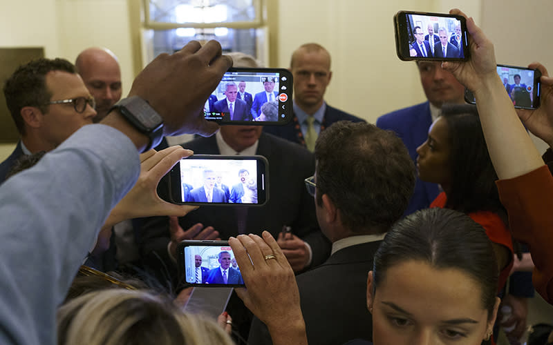 Speaker Kevin McCarthy (R-Calif.) is surrounded by reporters who are using smartphones to record his remarks