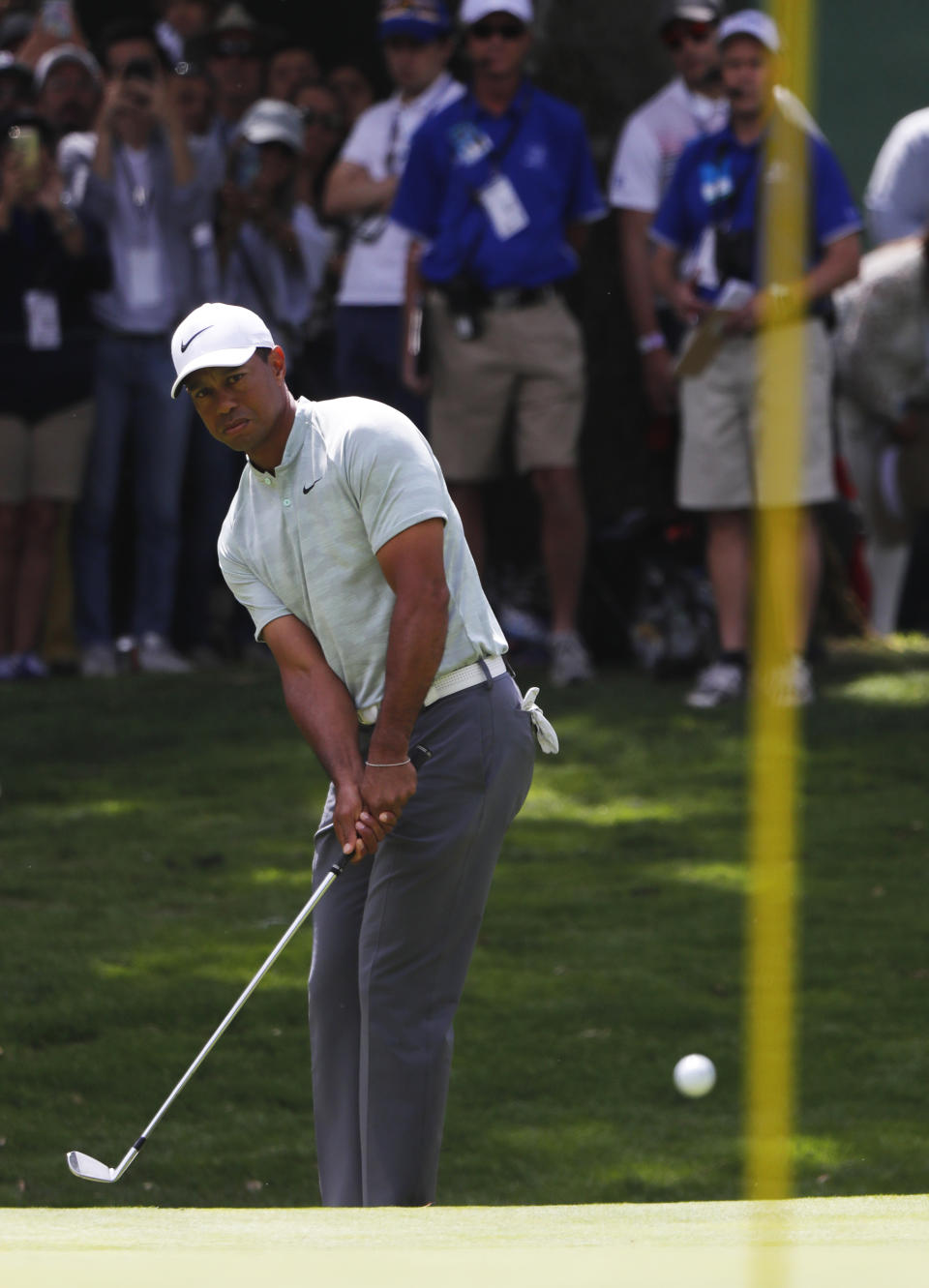 Tiger Woods chips the ball into the 1st hole green, on the third round of competition of the WGC-Mexico Championship at the Chapultepec Golf Club in Mexico City, Saturday, Feb. 23, 2019. (AP Photo/Marco Ugarte)