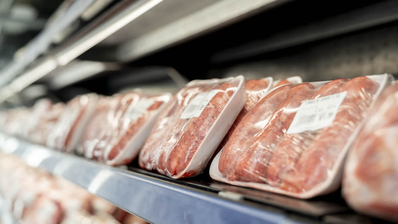 packages of sausage displayed on grocery store shelf