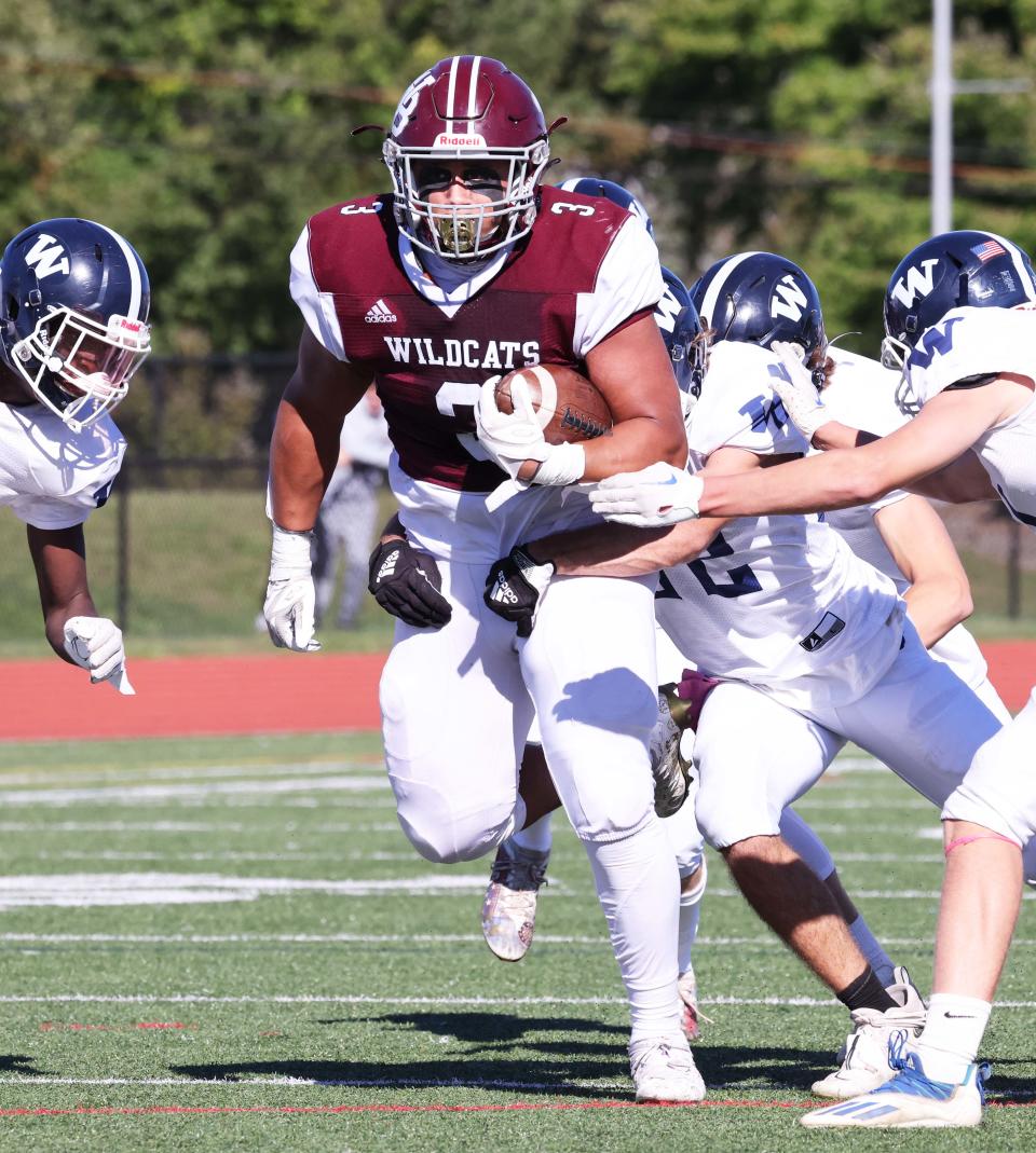 West Bridgewater running back Sean Carter makes the catch and is tackled by a host of Nantucket players during a game on Saturday, Sept. 24, 2022.  