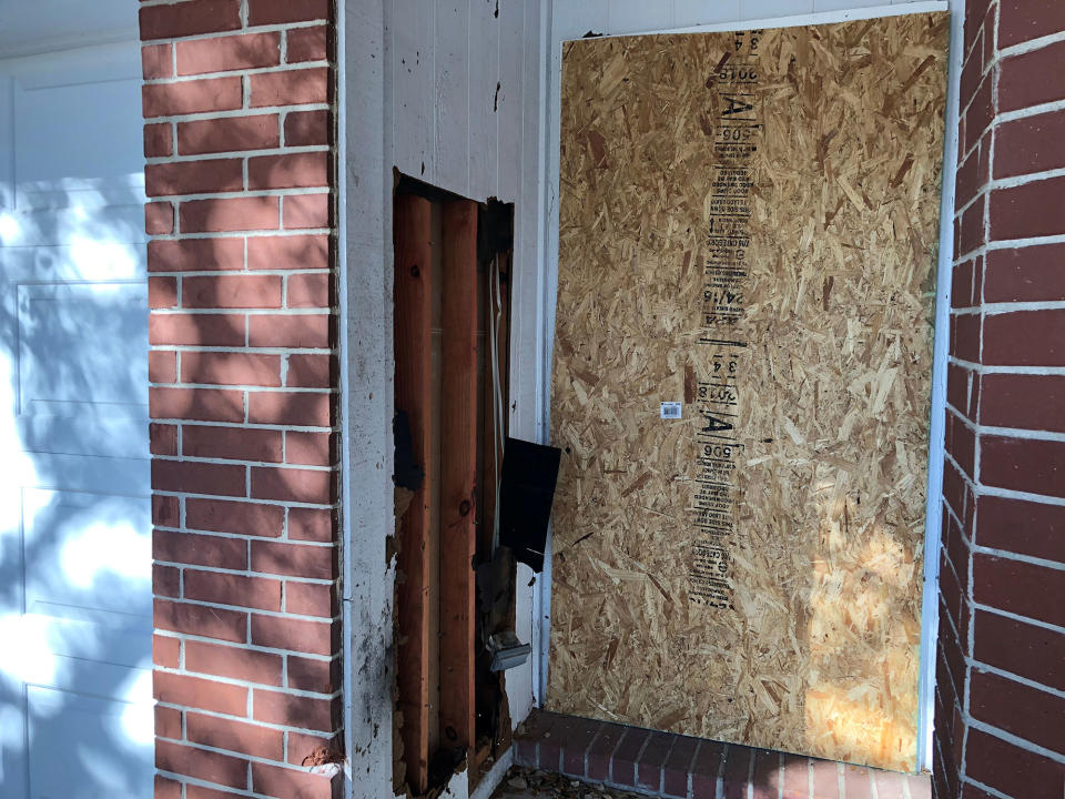 <p>The doorway of a home that was hit with a fatal parcel bomb on March 2, 2018 is seen boarded-up in Austin, Texas, March 12, 2018. (Photo: Jon Herskovitz/Reuters) </p>