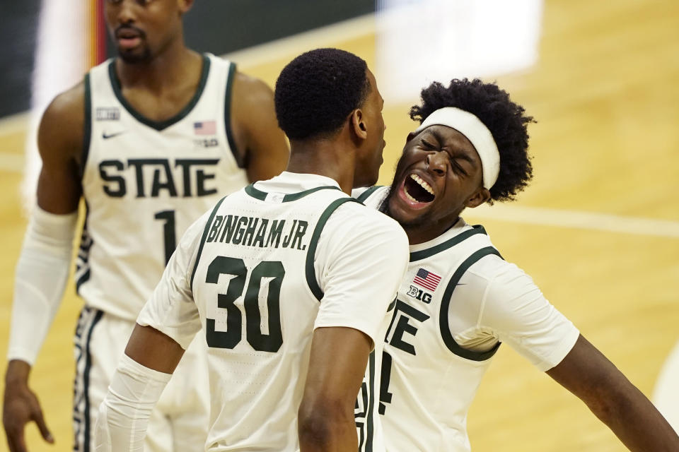 Michigan State forward Gabe Brown, right, and forward Marcus Bingham Jr. (30) celebrate a play during the second half of an NCAA college basketball game against Illinois, Tuesday, Feb. 23, 2021, in East Lansing, Mich. (AP Photo/Carlos Osorio)