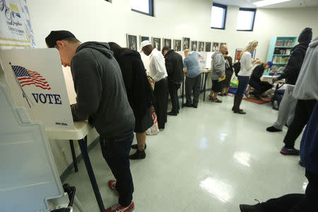 FILE PHOTO" People vote during the 2016 presidential election at the Anne Douglas Center at the Los Angeles Mission in Los Angeles, California, U.S., November 8, 2016. REUTERS/Mario Anzuoni