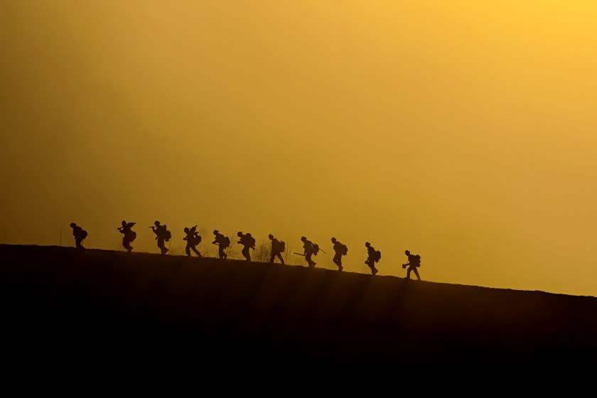 CHINO HILLS, CA - OCTOBER 27: Firefighting hand crew march on the hill Tuesday, Oct. 27, 2020 above Chino Hills, CA. (Irfan Khan / Los Angeles Times)