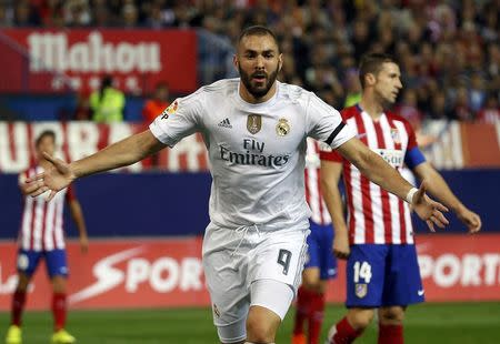 Real Madrid's Karim Benzema celebrates after scoring a goal during their Spanish first division derby soccer match against Atletico Madrid at the Vicente Calderon stadium in Madrid, Spain, October 4, 2015. REUTERS/Andrea Comas