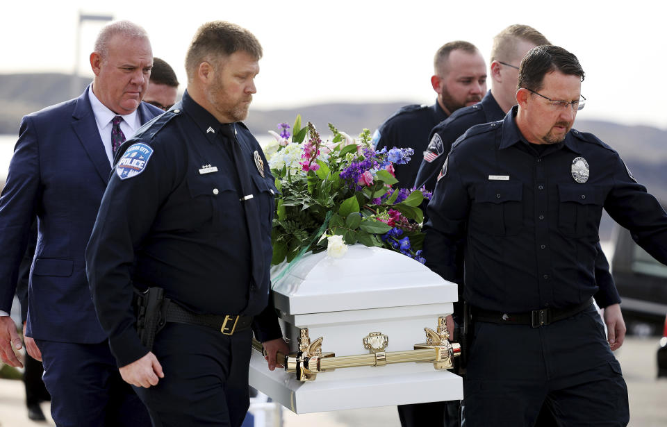 Law enforcement carry one of the children's caskets to a hearse following funeral services of the Haight and Earl families in La Verkin, Utah, on Friday, Jan. 13, 2023, in La Verkin, Utah. Tausha Haight, her mother, Gail Earl, and her five children were shot and killed by her husband Jan. 4. (Scott G Winterton/The Deseret News via AP)