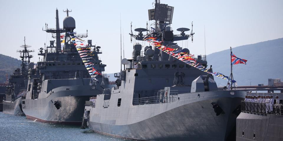 Two warships decorated with flags.