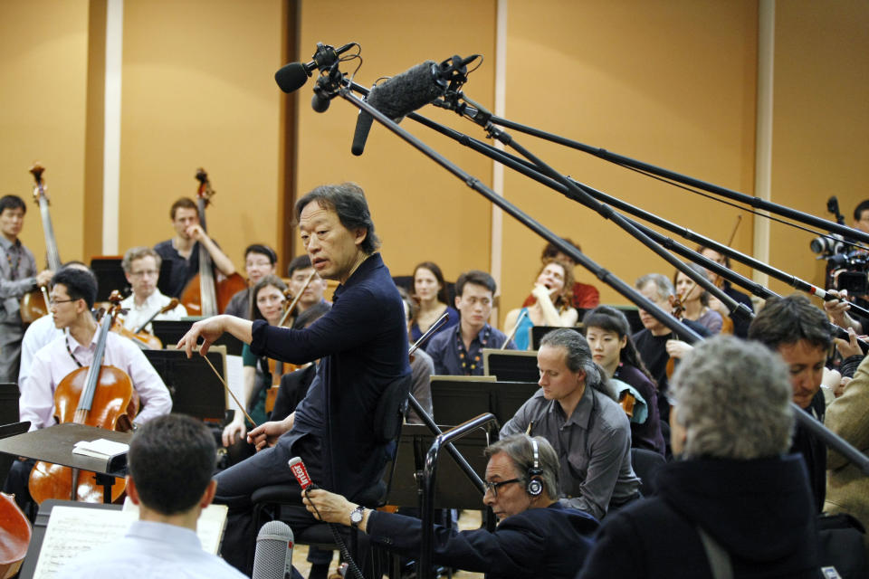 South Korean conductor Chung Myung-whun, center, gives instructions during a rehearsal to members of North Korea's Unhasu Orchestra with the Radio France Philharmonic Orchestra in Paris, Tuesday, March 13, 2012. Musicians from the Unhasu Orchestra will perform a piece together with Radio France Philharmonic Orchestra, directed by South Korean conductor Chung Myung-whun, in Paris, Wednesday, March 14. (AP Photo/Remy de la Mauviniere)
