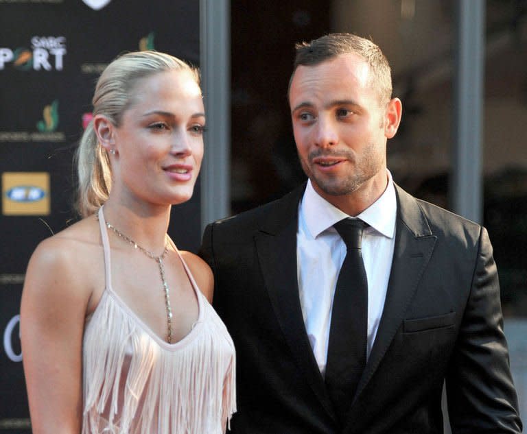South Africa's Olympic sprint star Oscar Pistorius and his model girlfriend Reeva Steenkamp are seen at Feather Awards in Johannesburg on November 4, 2012. Steenkamp, who was allegedly shot dead by Pistorius, will appear in a pre-recorded celebrity reality TV show in South Africa, two days after her death shocked the nation and the world