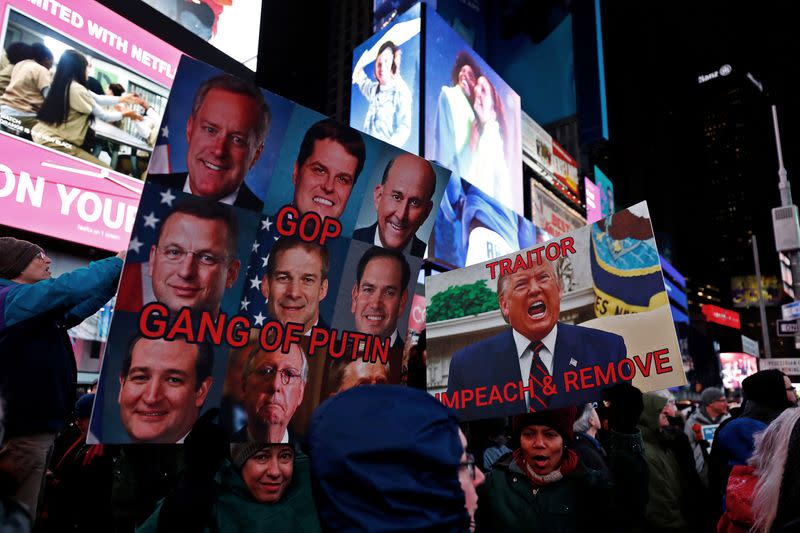 Demonstrators gather to demand the impeachment and removal of U.S. President Donald Trump during a rally at Times Square in New York City