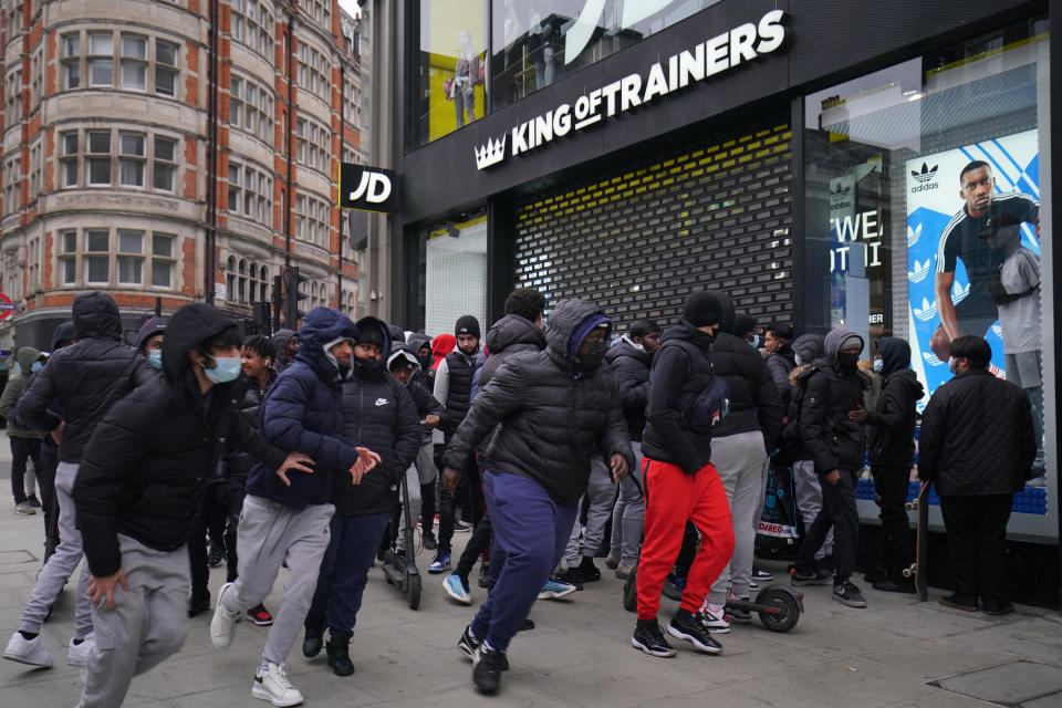 Early morning shoppers gather outside the JD Sports store in Oxford Street, London, waiting for the store to reopen as England takes another step back towards normality with the further easing of lockdown restrictions. Picture date: Monday April 12, 2021.