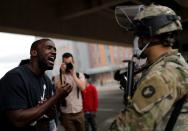 Man confronts a National Guard member guarding the area in the aftermath of a protest in Minneapolis