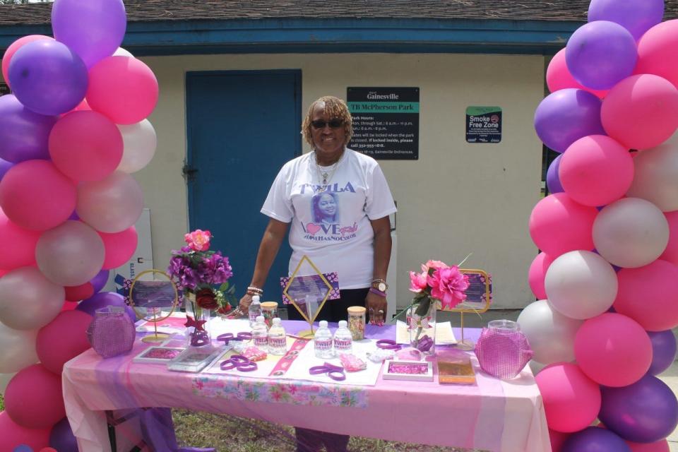 Felicia Carnegie-Parker stands by the information table at the Twila Love Fest held Saturday at T.B. McPherson Park in southeast Gainesville to celebrate the life of  her daughter, the late Twila Robinson-Browder, a 1990 Eastside High School graduate who was killed in a car accident in 2018.