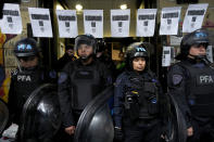 Police stand at the entrance of the National Institute against Discrimination, Xenophobia, and Racism, to prevent laid off workers from entering their workplace, in Buenos Aires, Argentina, Wednesday, April 3, 2024. According to the State Workers Association, more than 11 thousand dismissals of state employees have been carried out by Javier Milei’s government. (AP Photo/Natacha Pisarenko)