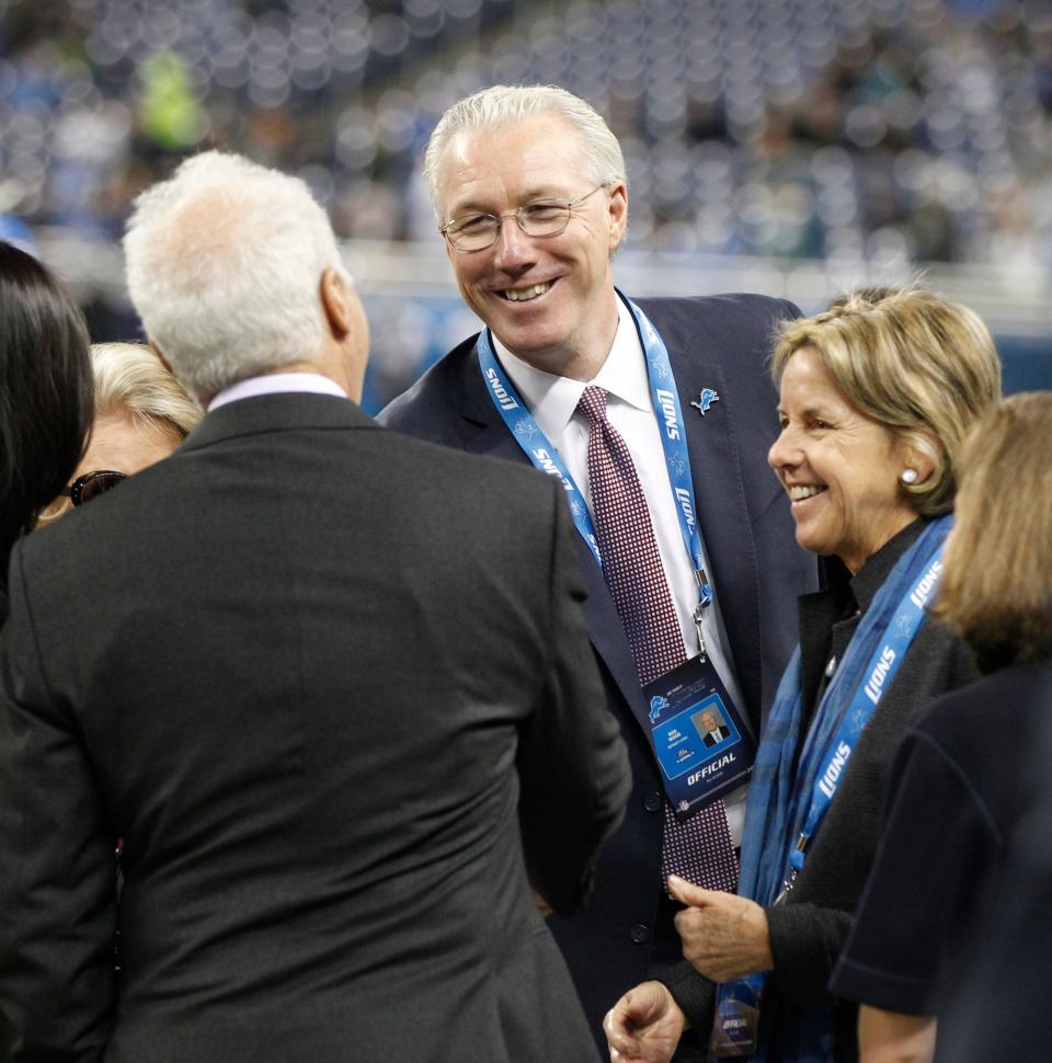 Detroit Lions Team President Rod Wood, center, next to Lions Vice Chair Sheila Ford Hamp shakes hands with Philadelphia Eagles owner Jeffrey Lurie, left back to the camera, on the sidelines before the Lions' football game against the Philadelphia Eagles on November 26, 2015, in Detroit.