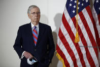 Senate Majority Leader Mitch McConnell of Ky., holds a face mask used to protect against the spread of the new coronavirus as he attends a news conference on Capitol Hill in Washington, Tuesday, May 12, 2020. (AP Photo/Patrick Semansky)