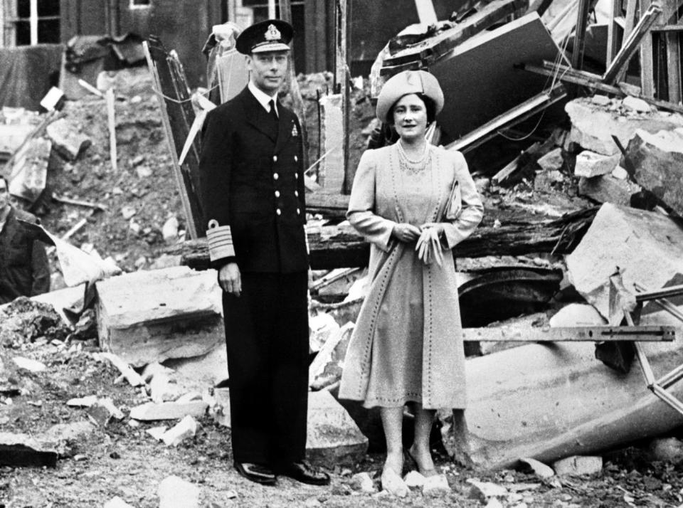 King George VI and the Queen Mother stand among ruins in the Blitz, 1940