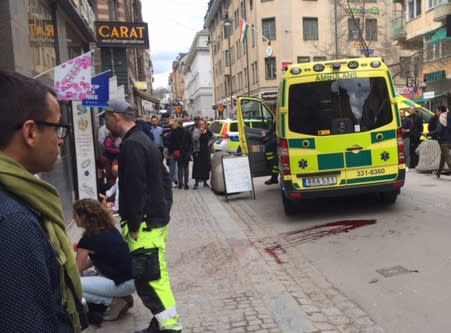 Blood is smeared on the street at the scene after a truck crashed into a department store injuring several people in central Stockholm, Sweden, Friday April 7, 2017. Swedish Prime Minister Stefan Lofven says everything indicates a truck that has crashed into a major department store in downtown Stockholm is "a terror attack." (Rose-Marie Otter/ TT News Agency via AP)