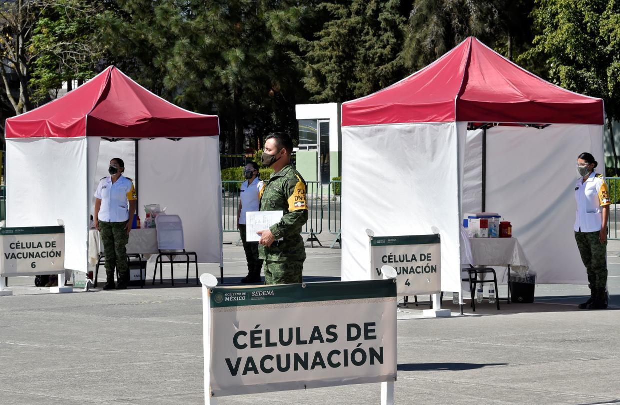 Medical personnel from different institutions and the Mexican Army wait to start applying the Pfizer/BioNTech COVID-19 vaccine, at the Military Field Number 1A in Mexico City on December 28, 2020. - Mexico will first apply the vaccine to all health personnel and the elderly as part of their mass immunization program. (Photo by Alfredo ESTRELLA / AFP) (Photo by ALFREDO ESTRELLA/AFP via Getty Images)