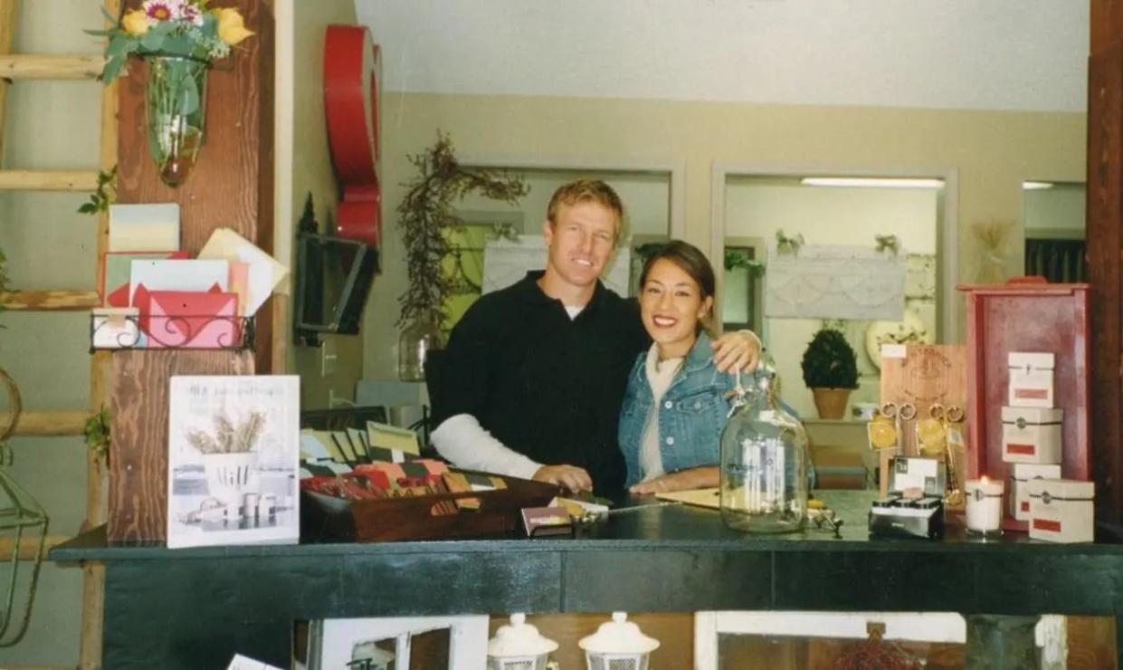 chip and joanna gaines standing behind counter