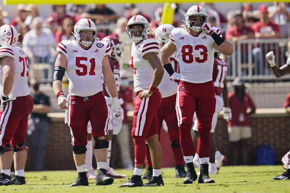 Nebraska offensive lineman Cameron Jurgens (51), quarterback Adrian Martinez, center, and tight end Travis Vokolek (83) look at the scoreboard following a penalty in the first half of an NCAA college football game against Oklahoma, Saturday, Sept. 18, 2021, in Norman, Okla. (AP Photo/Sue Ogrocki)