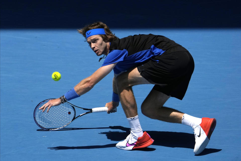Andrey Rublev of Russia plays a forehand return to Daniel Evans of Britain during their third round match at the Australian Open tennis championship in Melbourne, Australia, Saturday, Jan. 21, 2023. (AP Photo/Ng Han Guan)