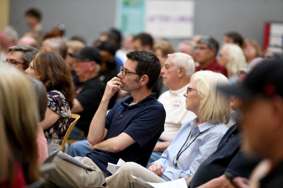 The audience listens to answers from the Canton mayoral candidates Thursday at a League of Women Voters of the Canton Area event at Timken Commons.