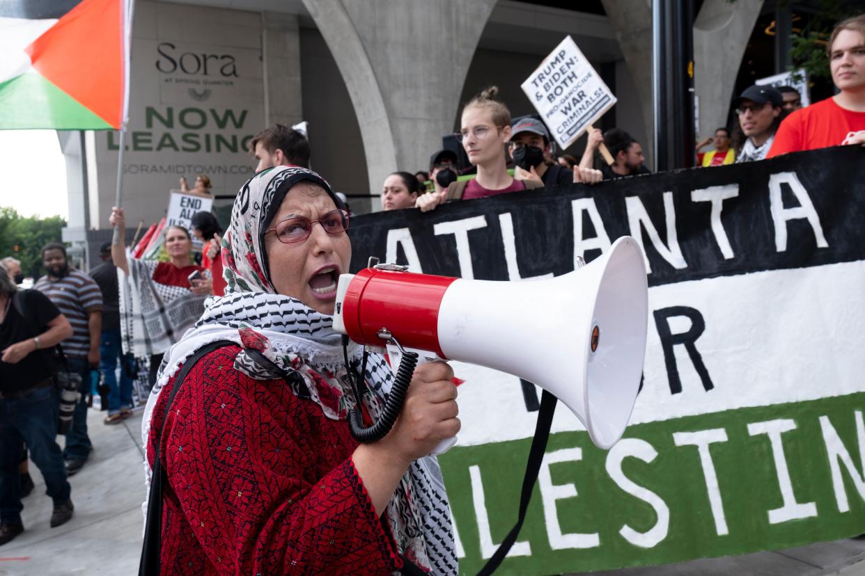 Jawahir Kamal leads pro-Palestinian protesters in a chant as they gather before a presidential debate between President Joe Biden and Republican presidential candidate former President Donald Trump in Atlanta (AP)