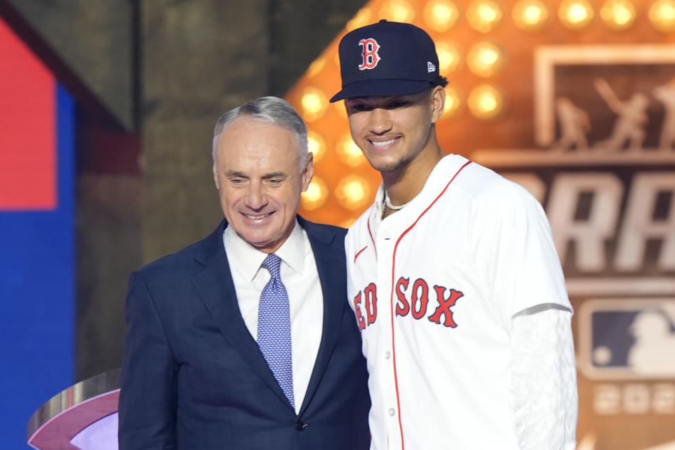 Major League Baseball Commissioner Rob Manfred,, left, poses with Braden Montgomery who was selected 12th overall by the Boston Red Sox in the first round of the MLB baseball draft in Fort Worth, Texas, Sunday, July 14, 2024. (AP Photo/LM Otero)