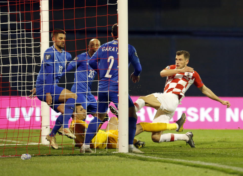Croatia's Borna Barisic, right, scores his side's opening goal during the Euro 2020 group E qualifying soccer match between Croatia and Azerbaijan at the Maksimir stadium in Zagreb, Croatia, Thursday, March 21, 2019. (AP Photo/Darko Bandic)