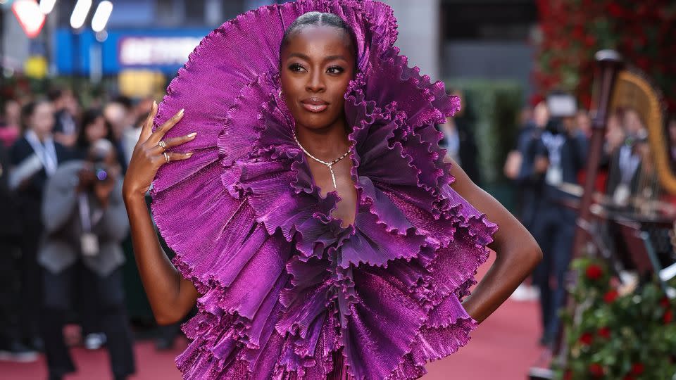 British television presenter AJ Odudu is all ruffles in a shimmery metallic purple extravaganza by Robert Wun. - Vianney Le Caer/Invision/AP