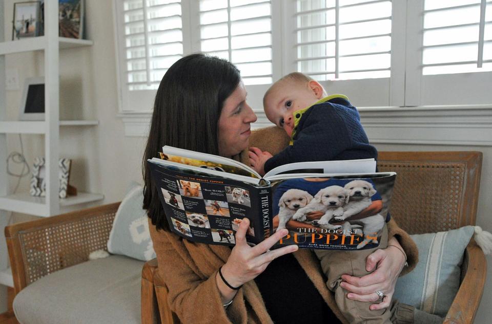 Emily Hayes and her son, Max, 1, enjoy a book inside their Duxbury home, Saturday, Feb. 25, 2023.