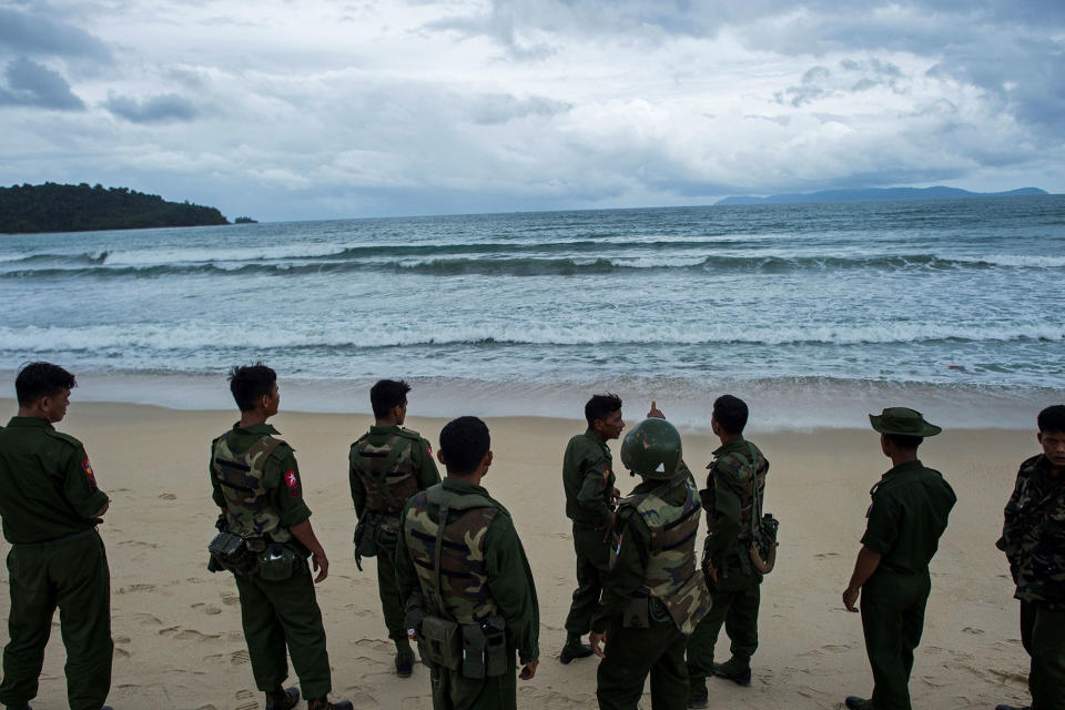 Military members look out to the sea