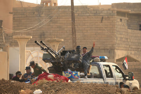 A member of Iraqi security forces gestures in Hammam al-Alil, south of Mosul, Iraq November 7, 2016. REUTERS/Thaier Al-Sudani