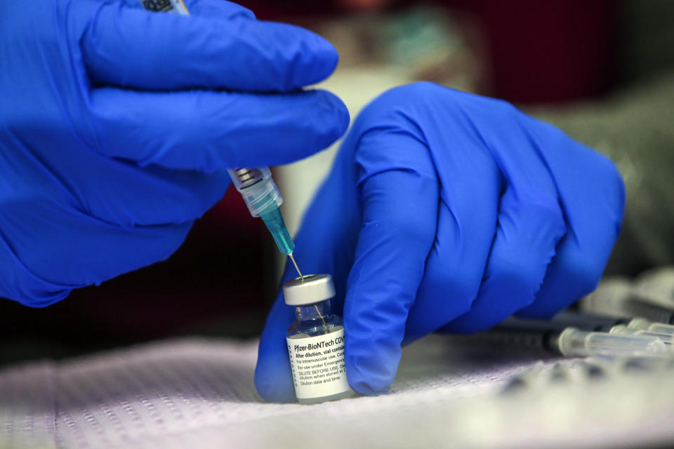 Alma Sevilla preparers Pfizer COVID-19 vaccine vial at a mobile vaccine clinic held at Roosevelt Park on Friday, May 14, 2021 in Los Angeles , CA. (Irfan Khan/Los Angeles Times via Getty Images)