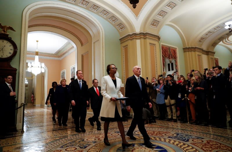 House Clerk Johnson and House Sergeant at Arms Irving carry impeachment articles during procession at the U.S. Capitol in Washingto