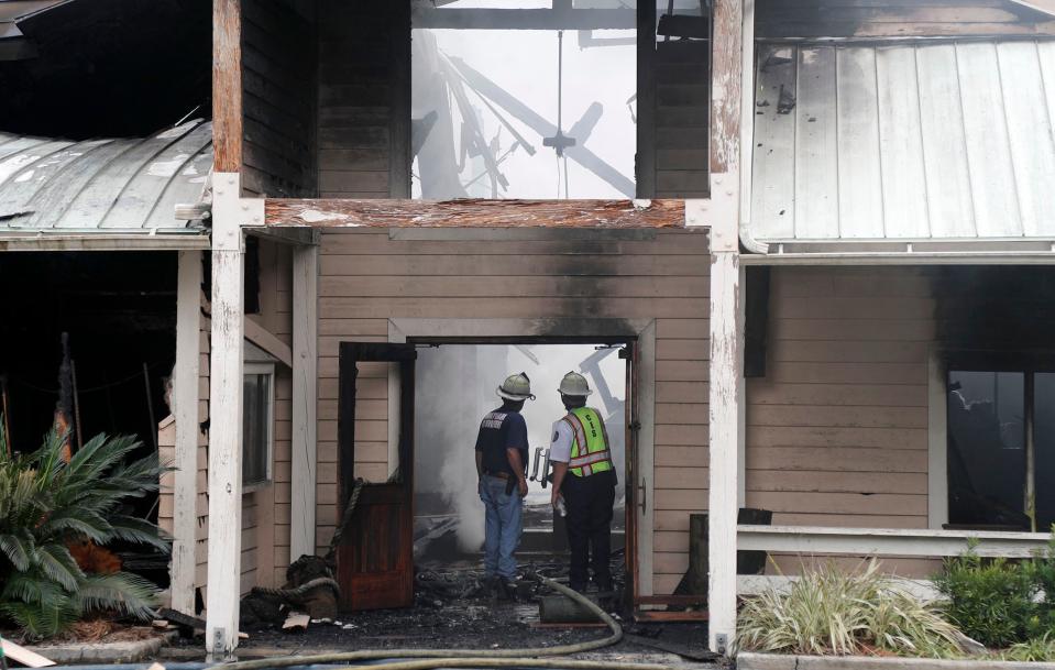 Chiefs from Chatham Emergency Services survey the damage to Pearl's Saltwater Grille after battling a fire that destroyed the restaurant on Thursday.