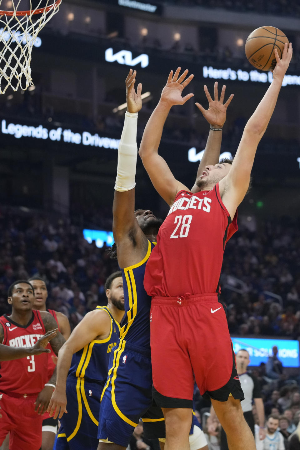 Houston Rockets center Alperen Sengun (28) shoots while defended by Golden State Warriors center Kevon Looney during the first half of an NBA basketball game in San Francisco, Saturday, Dec. 3, 2022. (AP Photo/Godofredo A. Vásquez)