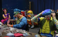 <p>Ringling Bros. clowns take a break between acts in “Clown Alley,” a private area backstage, Friday, May 5, 2017, in Providence, R.I. Clown Alley is not just a place: the private area backstage where clowns get ready to perform. It’s how the clowns refer to themselves, a mini-fraternity within the circus, and a microcosm of it. (Photo: Julie Jacobson/AP) </p>