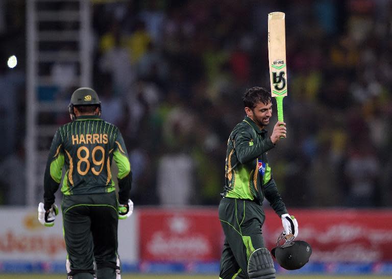 Pakistan's Shoaib Malik celebrates after reaching his century against Zimbabwe on May 26, 2015