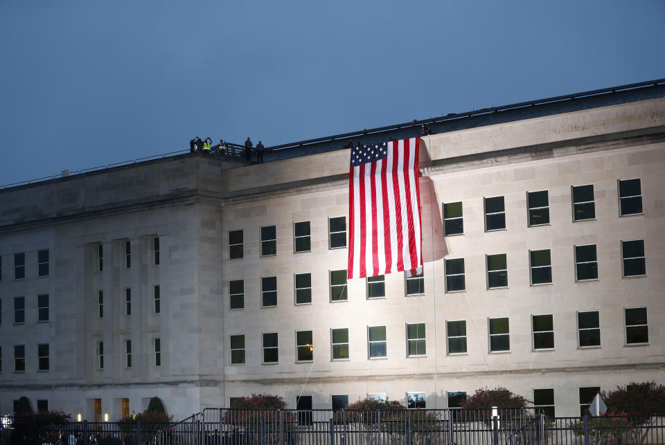 A U.S. flag is unfurled at sunrise on Tuesday, Sept. 11, 2018, at the Pentagon on the 17th anniversary of the Sept. 11, 2001, terrorist attacks. (AP Photo/Pablo Martinez Monsivais)