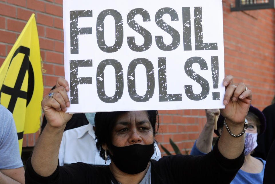 Climate activists protest demanding a renewable energy future for Africa during the Africa Energy Week, held at the V&A Waterfront in Cape Town, South Africa, Wednesday, Nov. 10, 2021. The protests coincide with the second week of the COP26, UN Climate Summit in Glasgow. (AP Photo/Nardus Engelbrecht)