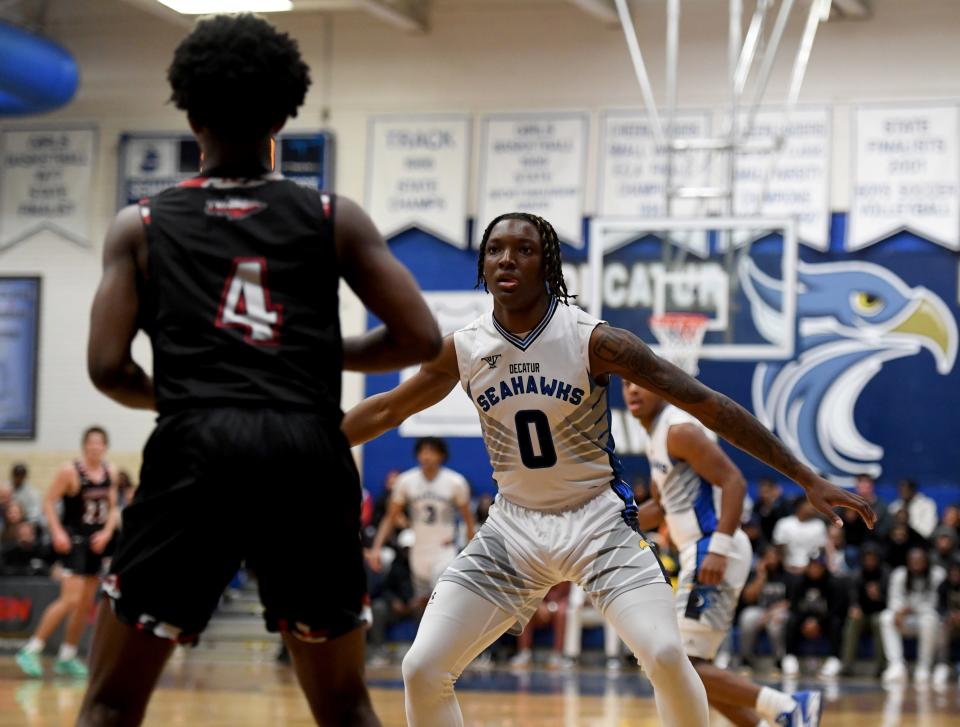 Decatur's Davin Chandler (0) guards Linganore's Brandon Donaldson (4) Friday, March 8, 2024, in the 3A State Quarterfinals in Berlin, Maryland. The Seahawks defeated the Lancers 63-43.