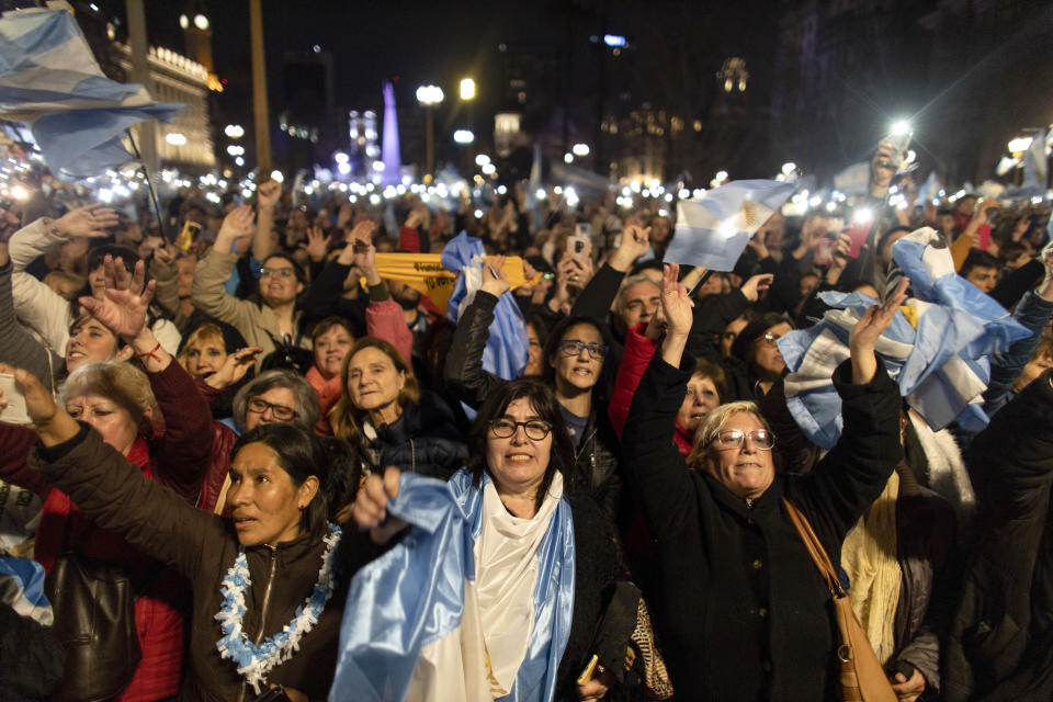 Supporters of President Mauricio Macri react as him and his Juliana Awada wave from the balcony of the government house, in Buenos Aires, Argentina, Saturday, Aug. 24, 2019. Following a social media campaign large numbers of people gathered in the center of Buenos Aires to show their support for Macri's administration. (AP Photo/Tomas F. Cuesta)