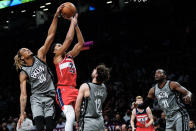 Brooklyn Nets' Nic Claxton (33) blocks a shot by Washington Wizards' Spencer Dinwiddie (26) during the first half of an NBA basketball game Monday, Oct. 25, 2021, in New York. (AP Photo/Frank Franklin II)